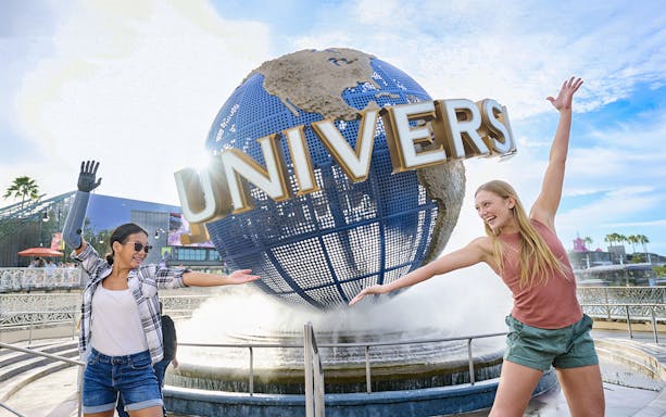 Guests in front of Universal globe and fountain at Universal Studios Orlando, Florida.