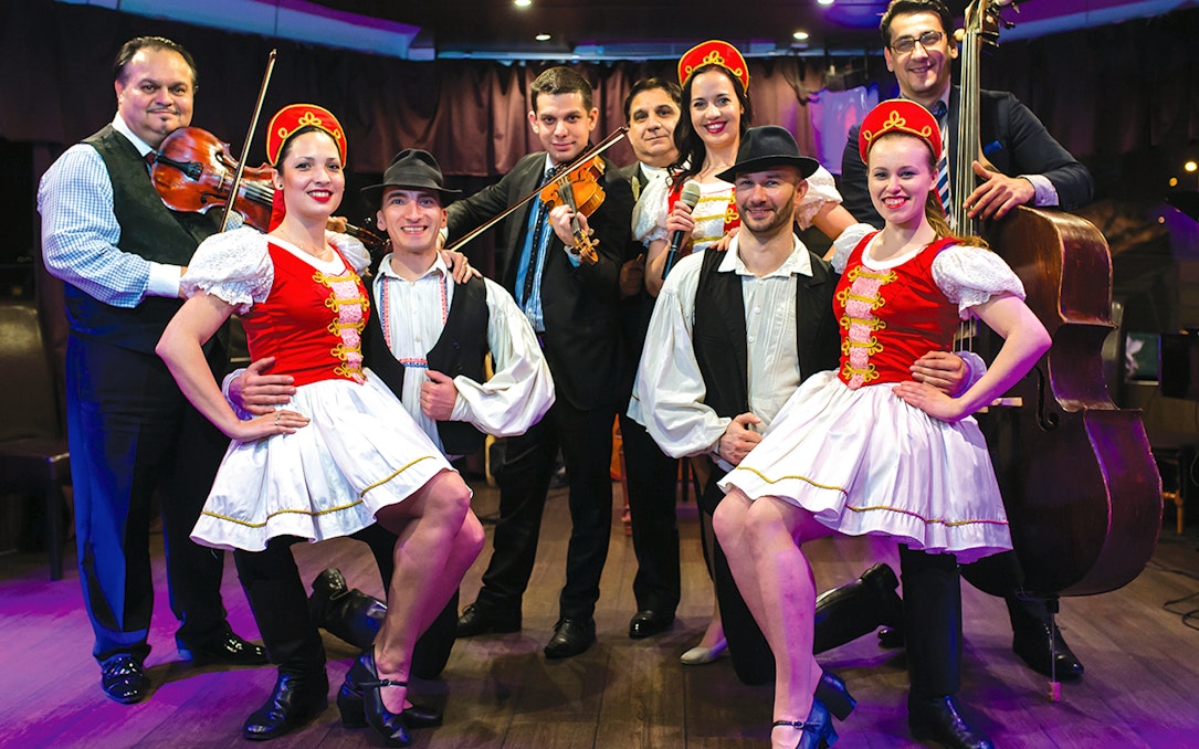 Folklore dancers and musicians performing on a Budapest dinner cruise.