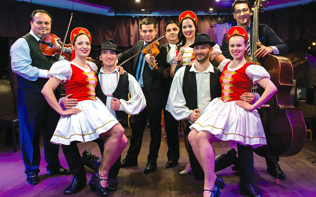 Folklore dancers and musicians performing on a Budapest dinner cruise.