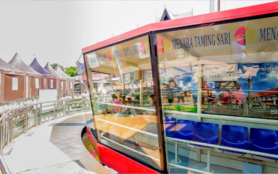 Menara Taming Sari observation deck with seated visitors in Melaka, Malaysia.
