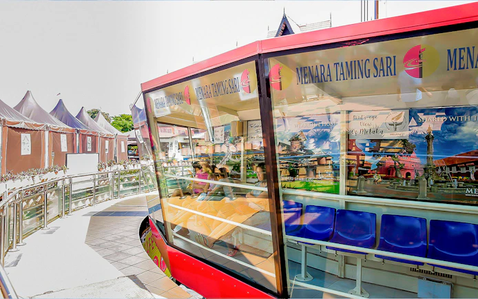 Menara Taming Sari observation deck with seated visitors in Melaka, Malaysia.