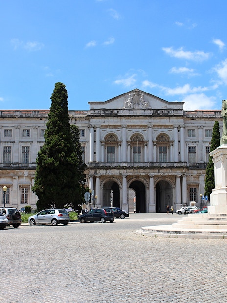 National Palace of Ajuda facade with statue in Lisbon, Portugal.