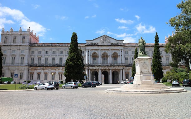 National Palace of Ajuda facade with statue in Lisbon, Portugal.