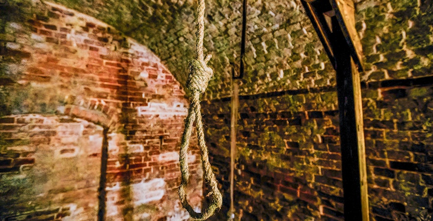 Hanging noose in a historic brick torture chamber.