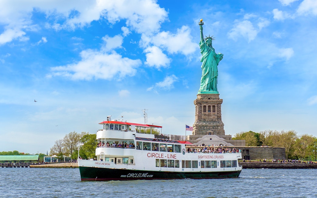 Circle Line cruise passing by the Statue of Liberty in New York City.