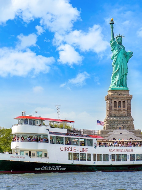Circle Line cruise passing by the Statue of Liberty in New York City.