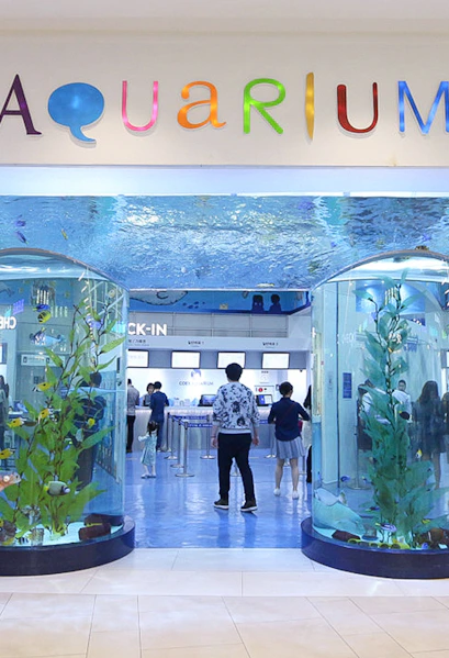 Entrance of Coex Aquarium with visitors and large fish tanks, Seoul, South Korea.