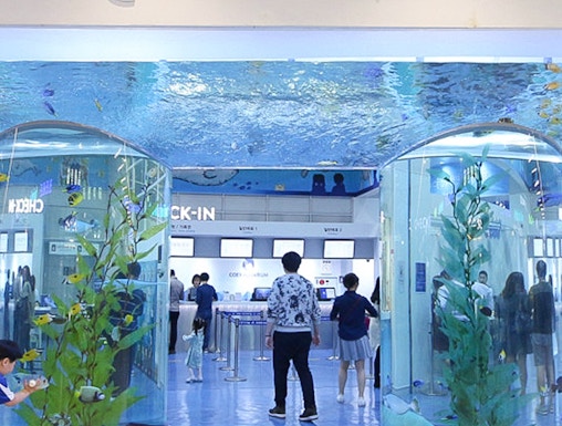 Entrance of Coex Aquarium with visitors and large fish tanks, Seoul, South Korea.
