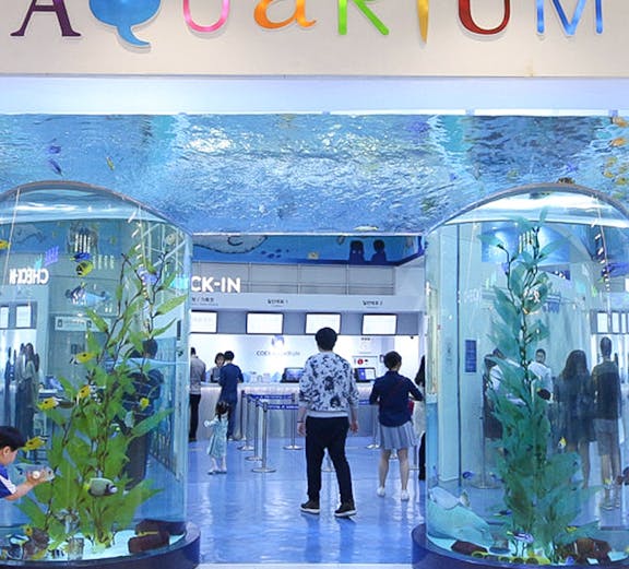 Entrance of Coex Aquarium with visitors and large fish tanks, Seoul, South Korea.