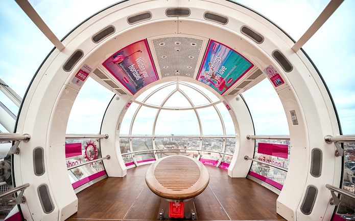 Interior view of a London Eye capsule overlooking the city skyline.