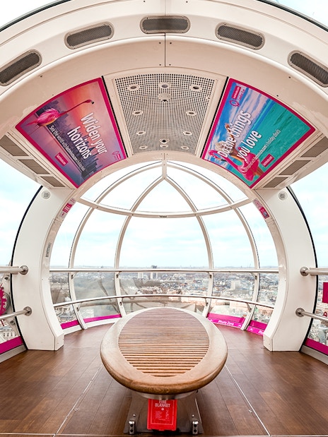 Interior view of a London Eye capsule overlooking the city skyline.