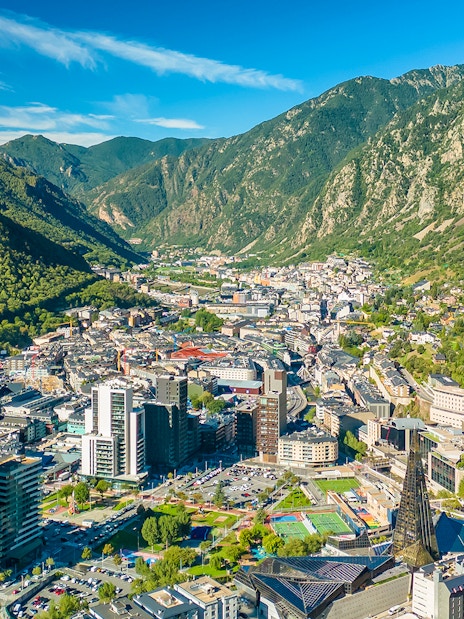 Aerial view of Andorra la Vella with surrounding mountains and cityscape.