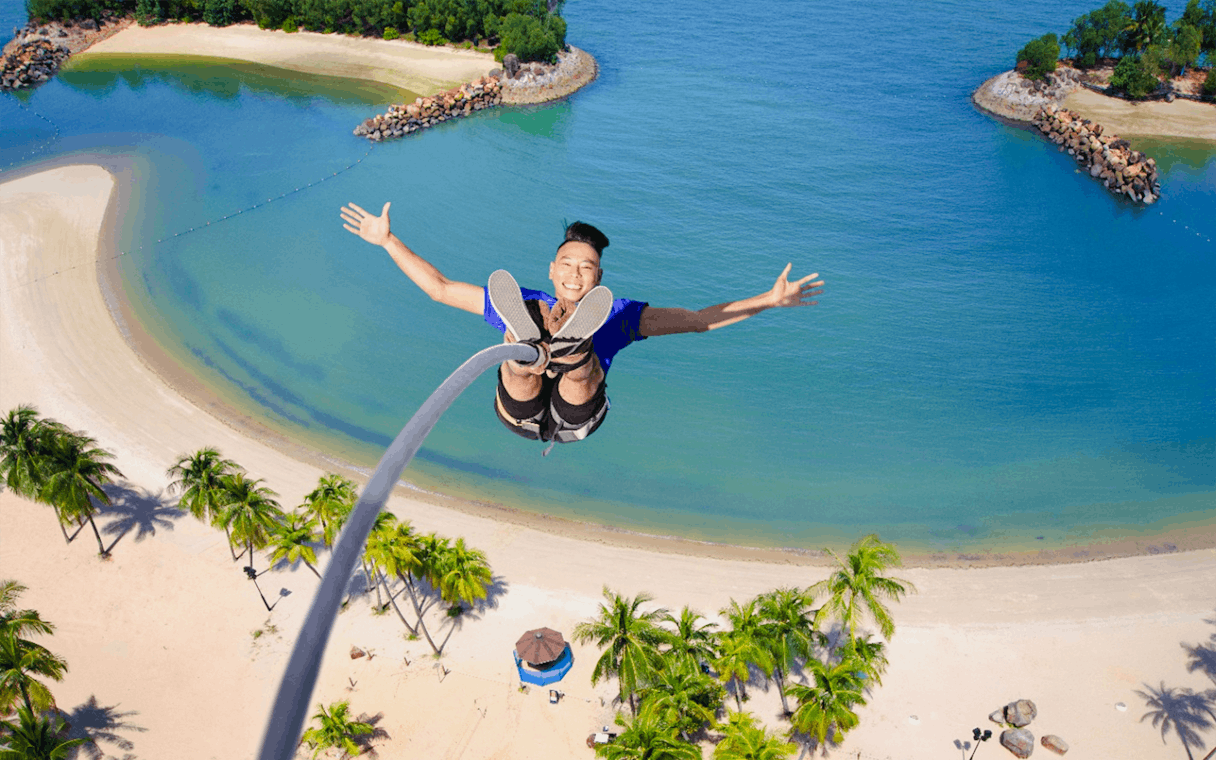 Bungee jumper over beach at Skypark Sentosa by AJ Hackett, Singapore.