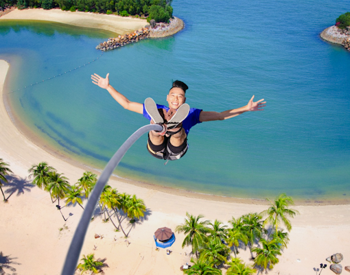Bungee jumper over beach at Skypark Sentosa by AJ Hackett, Singapore.