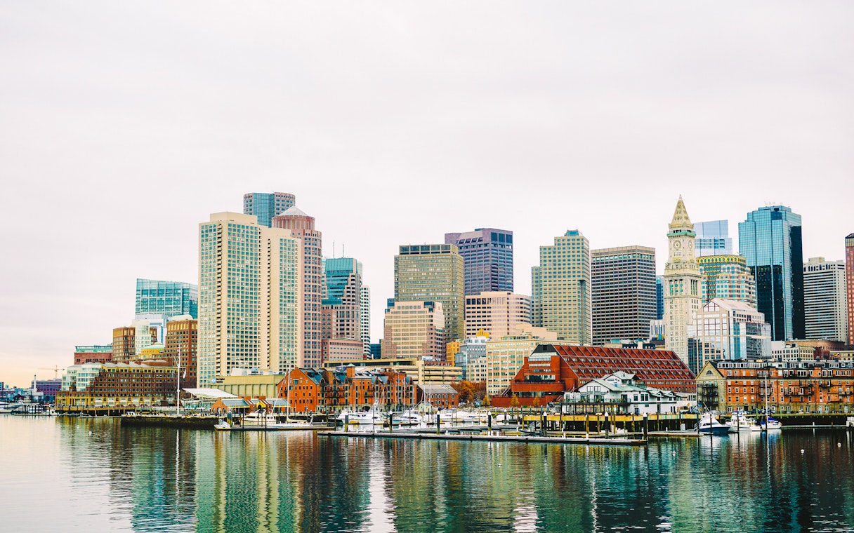 Boston Harbor waterfront skyline with historic and modern buildings.