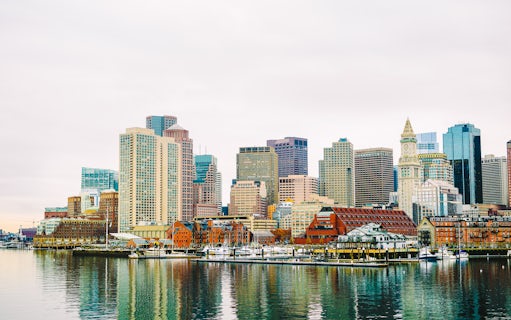 Boston Harbor waterfront skyline with historic and modern buildings.