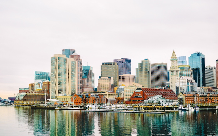 Boston Harbor waterfront skyline with historic and modern buildings.