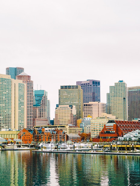 Boston Harbor waterfront skyline with historic and modern buildings.