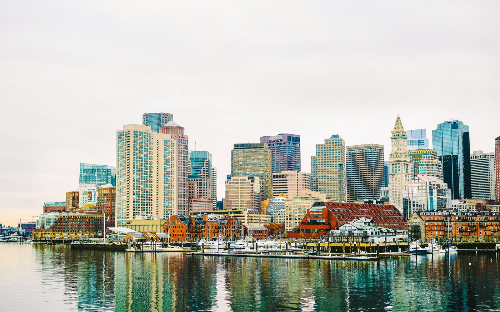 Boston Harbor waterfront skyline with historic and modern buildings.