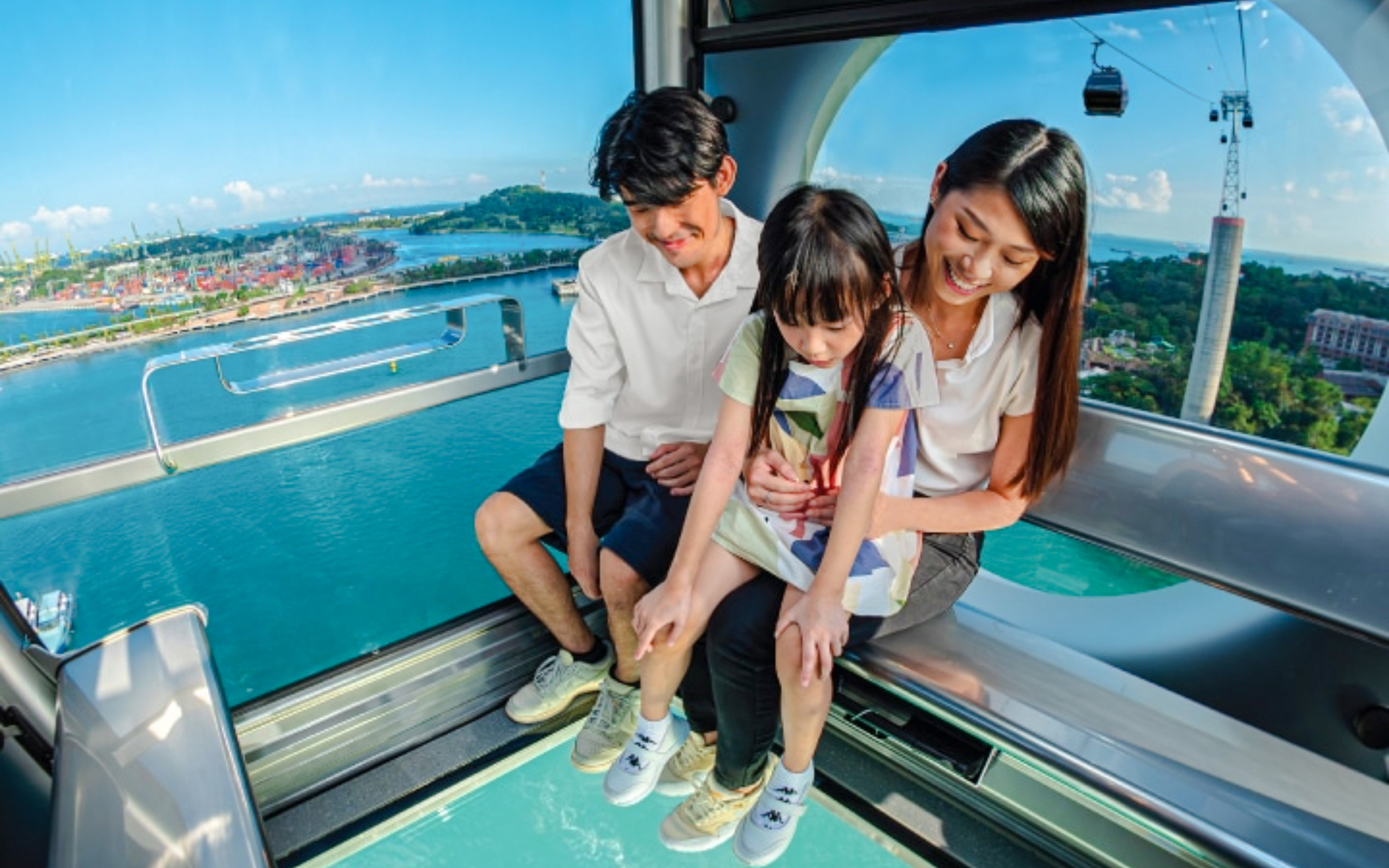 Family enjoying the view from the Sky Orb ride over the water.