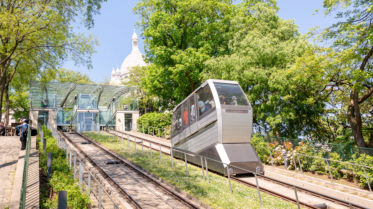 Funicular ascending Montmartre with Sacré-Cœur in the background, Paris tour.