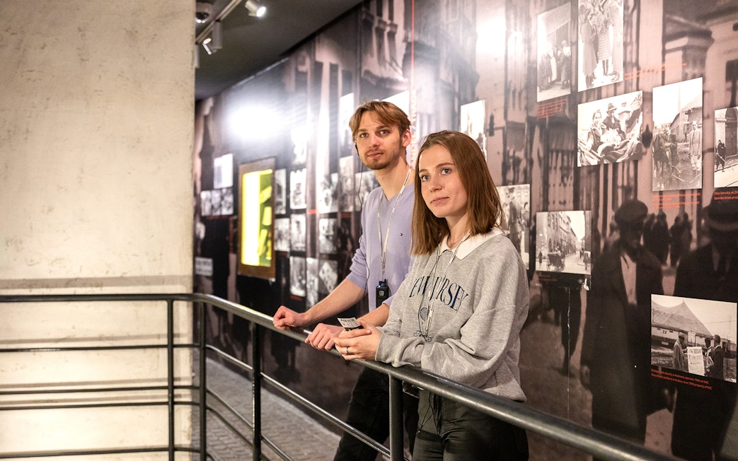 Couple exploring exhibits inside Oskar Schindler's Factory, Krakow.