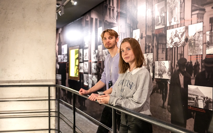 Couple exploring exhibits inside Oskar Schindler's Factory, Krakow.