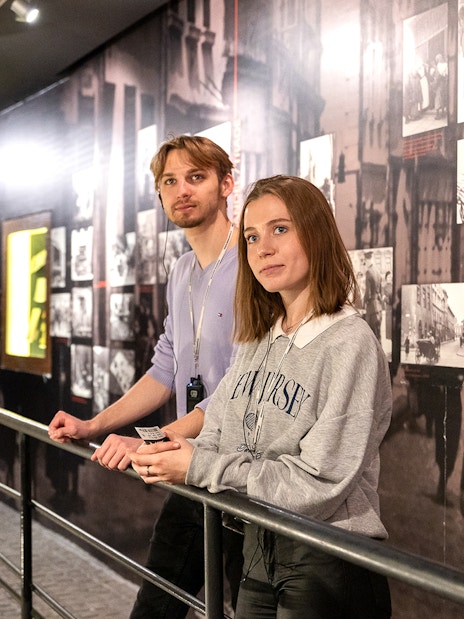 Couple exploring exhibits inside Oskar Schindler's Factory, Krakow.