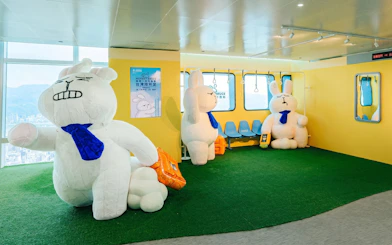 Large plush rabbits in a themed room at Taipei 101 Observatory.