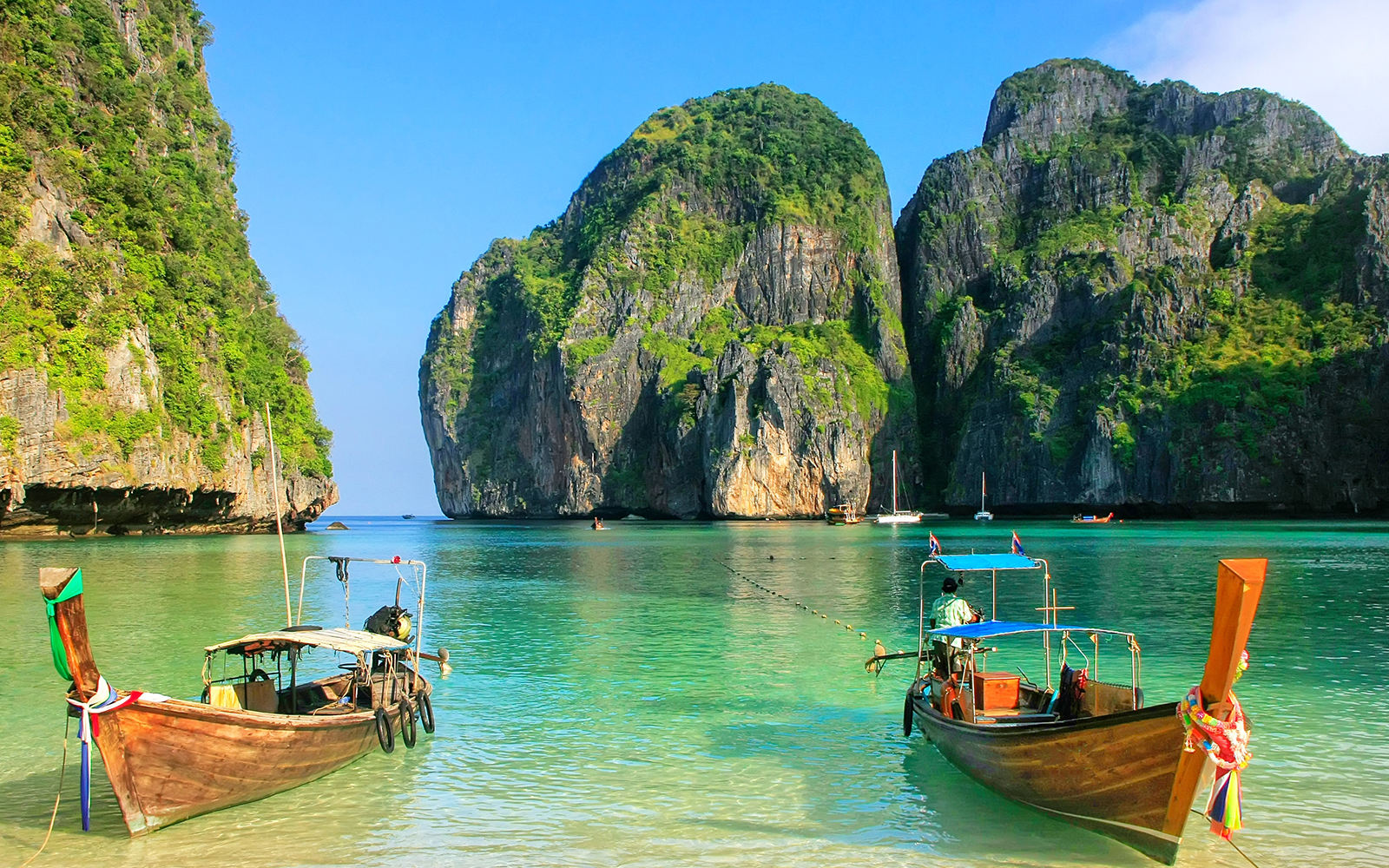 Phi Phi Le limestone cliffs and hidden lagoon with white-sand beach in Thailand.