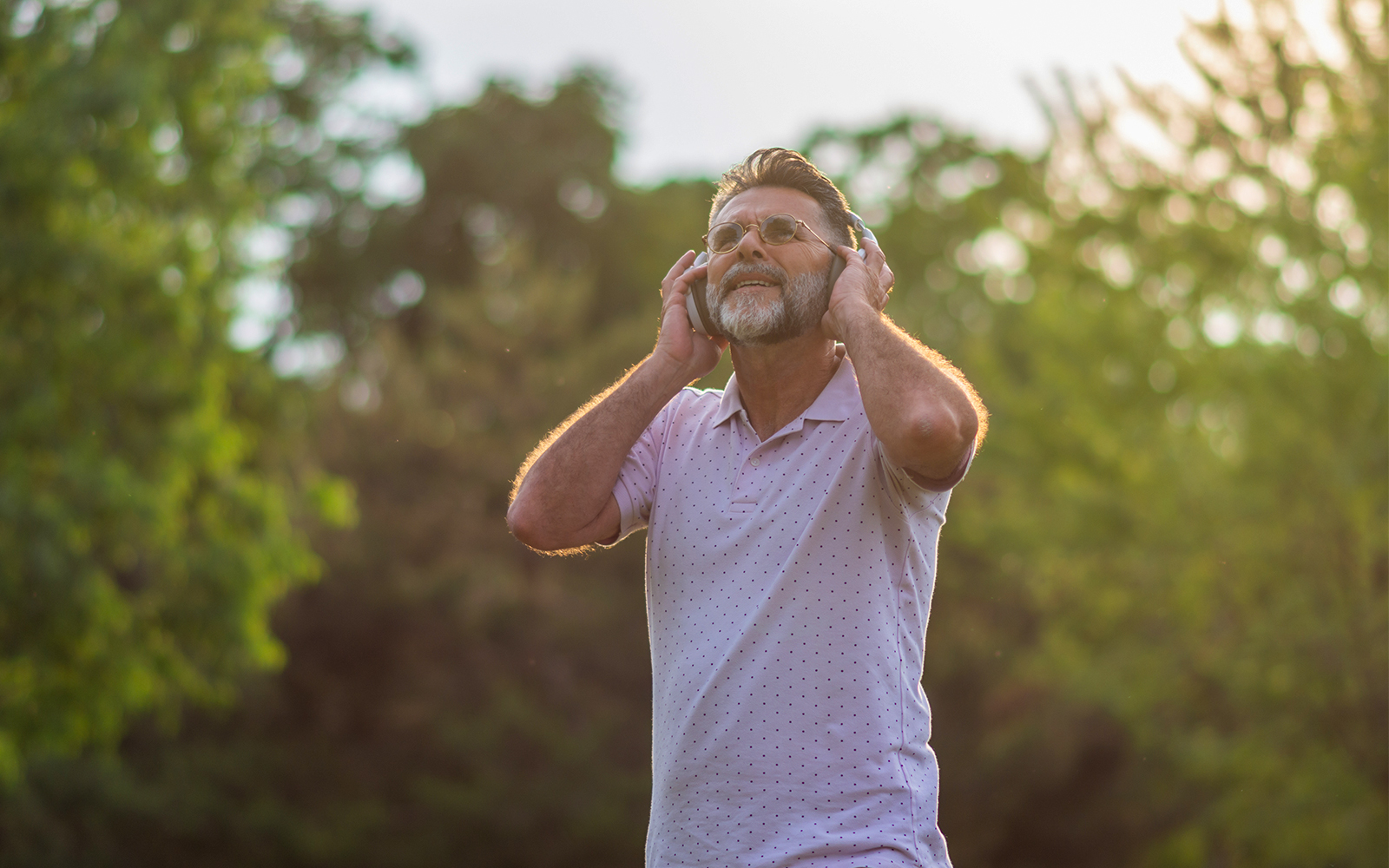 Man enjoying audio guide outdoors on Loch Ness and The Highlands day trip.