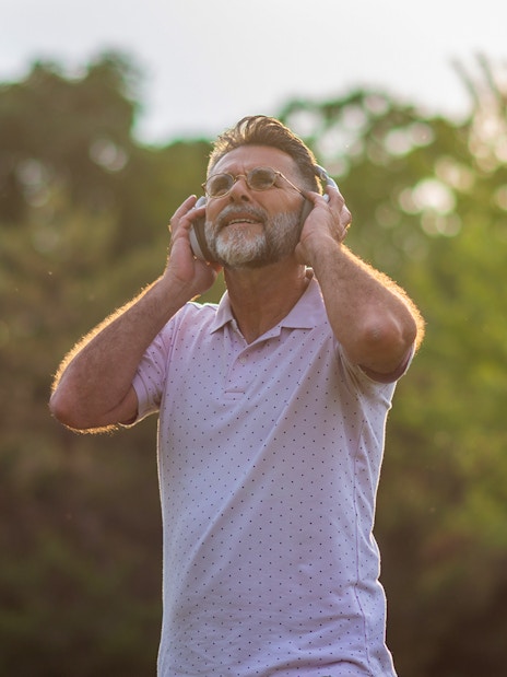 Man enjoying audio guide outdoors on Loch Ness and The Highlands day trip.