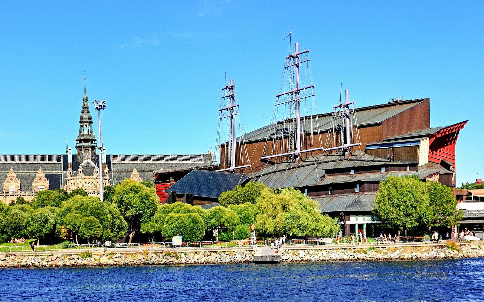 Djurgrden City Canal Cruise boat passing by lush greenery near Vasa Museum, Stockholm.