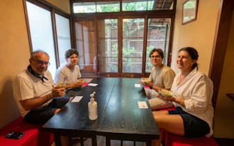 Family enjoying a tea ceremony in a traditional Japanese tea room.