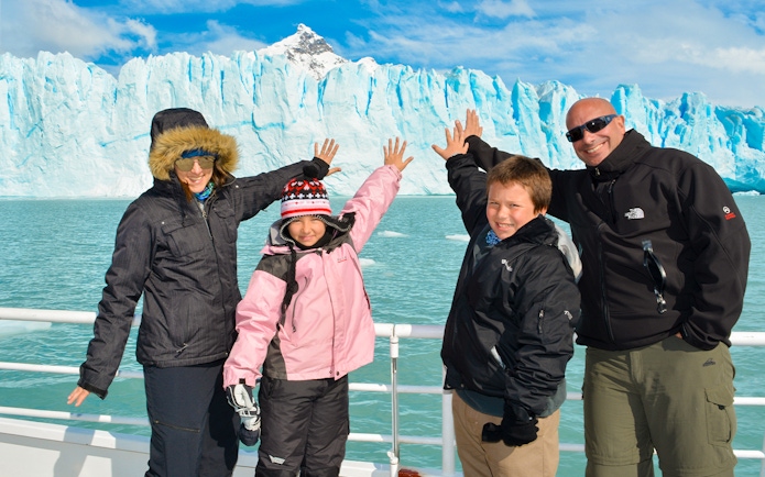 Tourists on a cruise posing in front of Perito Moreno Glacier, Argentina.