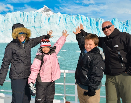 Tourists on a cruise posing in front of Perito Moreno Glacier, Argentina.