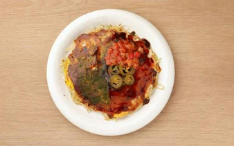 Hiroshima-style okonomiyaki with toppings on a plate, Micchan Sohonten Orizuru Tower, Hiroshima.