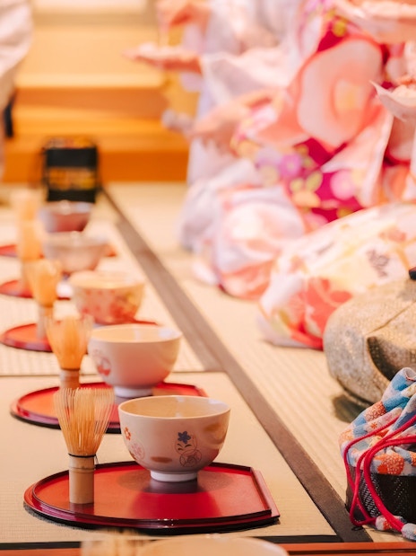 Tea ceremony in progress with participants in traditional attire, Japan.