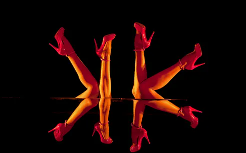 Dancers' legs in red heels performing at Crazy Horse Paris, Dubai Edition.