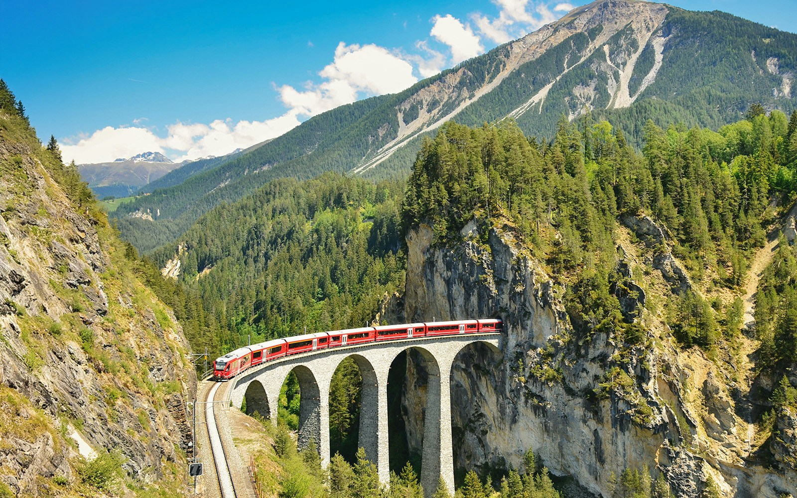 Railway bridge in Switzerland. Landwasser Viaduct in Graubunden near Davos Klosters Filisur. Railway company emblem.