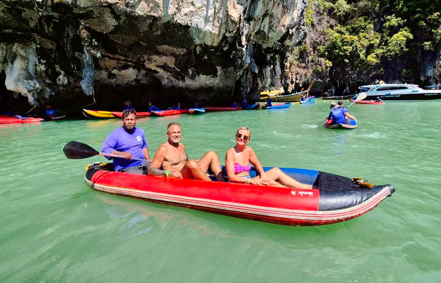Kayaking in Phang Nga Bay near limestone cliffs, Phuket day trip.