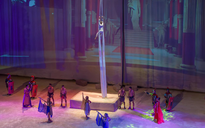 Aerial performer and actors in Roman-themed show at Terra Mitica, Spain.