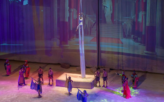 Aerial performer and actors in Roman-themed show at Terra Mitica, Spain.