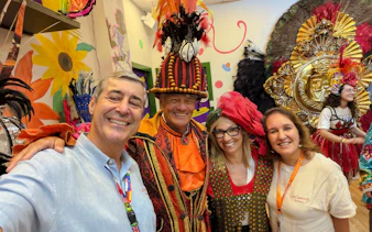 Carnival performers in colorful costumes backstage in Rio de Janeiro.