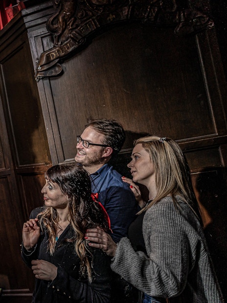 Judge in period costume engaging with visitors at York Dungeon courtroom.