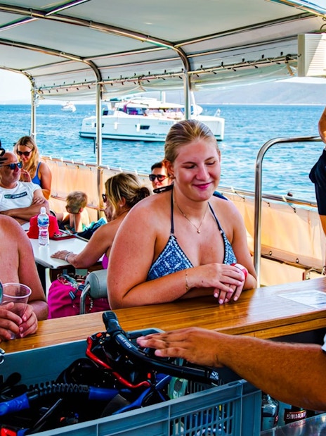 Guests enjoying drinks on a boat during Blue Lagoon and 3 Island tour from Split.