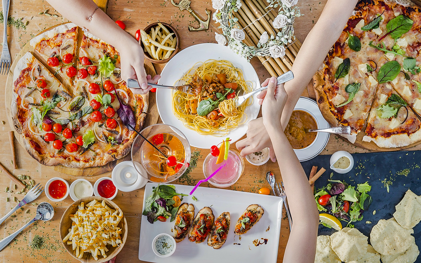 Lunch spread at Royal Albatross Dockside Bar, Singapore with pizza, pasta, and cocktails.