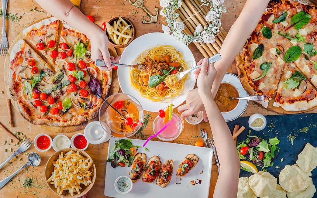 Lunch spread at Royal Albatross Dockside Bar, Singapore with pizza, pasta, and cocktails.