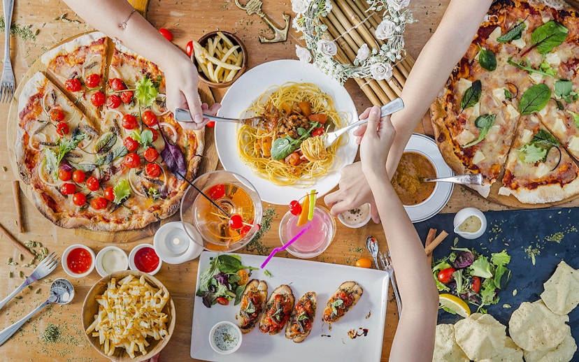 Lunch spread at Royal Albatross Dockside Bar, Singapore with pizza, pasta, and cocktails.