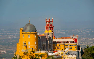 Pena Palace in Sintra with colorful towers and scenic views on a private half-day tour from Lisbon.